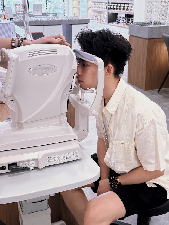 Customer having an eye scan at Moment Optical