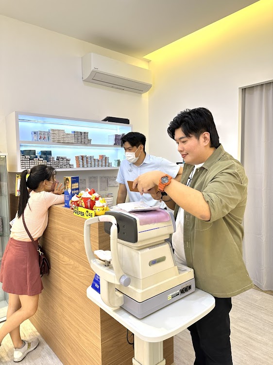 Customers at the eye-test counter, Moment Optical
